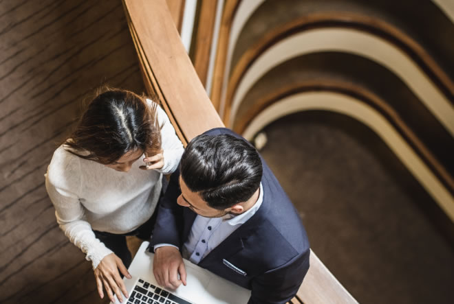 Two business professionals looking at laptop