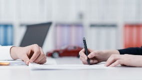 Lawyer showing a client where to sign