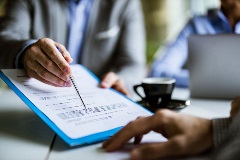 Lawyer showing a client where to sign