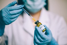 Nurse using a syringe to pull medicine