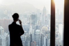 Business woman on a call looking over the city