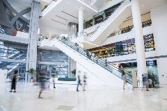 People going up an escalator at the mall